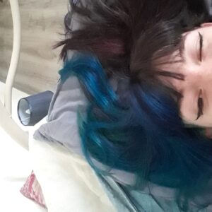 Jeune femme avec la moitié des cheveux colorés en bleu